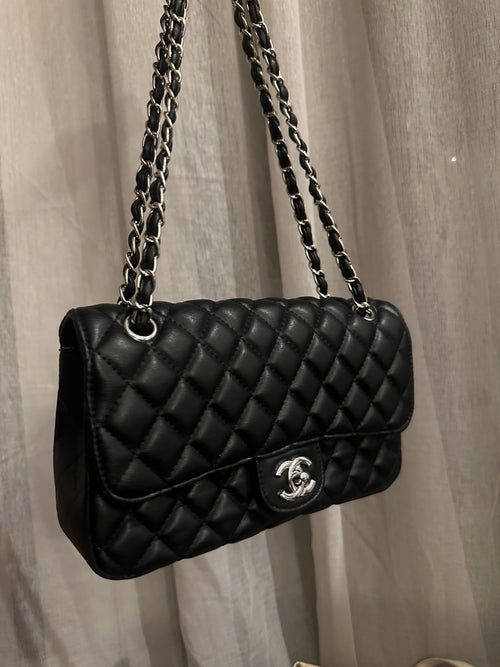 Black quilted shoulder bag with silver-tone hardware