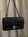 Black quilted shoulder bag with silver-tone hardware